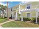 Inviting exterior of a two-story townhome with a well-maintained lawn and landscaping at 219 Pompano Se Dr # C, St Petersburg, FL 33705
