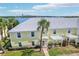 Charming yellow condo with well-manicured lawn and mature palm trees with a beautiful lake view at 219 Pompano Se Dr # C, St Petersburg, FL 33705