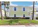 Inviting exterior of a two-story townhome with a well-maintained lawn and landscaping at 219 Pompano Se Dr # C, St Petersburg, FL 33705