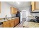 Modern kitchen featuring granite countertops, stainless steel appliances, and wooden cabinets at 219 Pompano Se Dr # C, St Petersburg, FL 33705