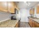 Modern kitchen featuring granite countertops, stainless steel appliances, and wooden cabinets at 219 Pompano Se Dr # C, St Petersburg, FL 33705