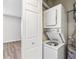 A convenient laundry area featuring a stacked washer and dryer unit and storage space at 219 Pompano Se Dr # C, St Petersburg, FL 33705