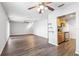 Spacious open-concept living area with hardwood floors connecting to the kitchen with modern appliances at 219 Pompano Se Dr # C, St Petersburg, FL 33705
