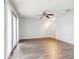 Bright living room with updated flooring, a ceiling fan, and sliding glass doors to the outside at 219 Pompano Se Dr # C, St Petersburg, FL 33705