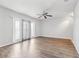 Bright living room with updated flooring, a ceiling fan, and sliding glass doors to the outside at 219 Pompano Se Dr # C, St Petersburg, FL 33705