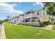 Charming condo with outdoor patios, stairs to upper level, and green backyard at 219 Pompano Se Dr # C, St Petersburg, FL 33705