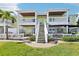 Charming condo with outdoor patios, stairs to upper level, and green backyard at 219 Pompano Se Dr # C, St Petersburg, FL 33705