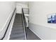 Carpeted stairwell with iron railing and artwork at 219 Pompano Se Dr # C, St Petersburg, FL 33705