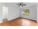 Bright bedroom with hardwood floors, a ceiling fan, and an ensuite bathroom at 2313 Palm Ave, Seffner, FL 33584