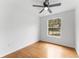 Bright bedroom featuring hardwood floors, a ceiling fan, and a window offering natural light at 2313 Palm Ave, Seffner, FL 33584