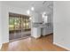 Bright kitchen area with white cabinets, quartz countertops, and sliding door to a patio at 2313 Palm Ave, Seffner, FL 33584