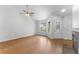 Bright living room featuring hardwood floors, a ceiling fan, and a decorative front door at 2313 Palm Ave, Seffner, FL 33584