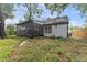 Back of the house shows a screened-in porch and siding at 2313 Palm Ave, Seffner, FL 33584