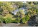 An aerial view of the house showcases a waterfront property with pool and lush landscaping at 2416 S 46Th St, Tampa, FL 33619