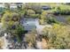 Aerial view showcases a private pool, lush landscaping, and serene waterfront location, enhancing this home's appeal at 2416 S 46Th St, Tampa, FL 33619
