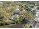 An aerial shot highlights the house's enviable canal-side location, offering privacy amidst lush tree coverage at 2416 S 46Th St, Tampa, FL 33619