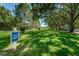 Scenic pet walk area with lush green grass, mature trees, and open space for residents to enjoy at 2690 Coral Landings Blvd # 722, Palm Harbor, FL 34684