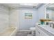 Bathroom featuring a shower-tub combo, modern vanity, and elegant decor at 2770 Keats Ter # C, Palm Harbor, FL 34684