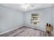 Empty bedroom featuring updated floors, natural light, and a ceiling fan at 2770 Keats Ter # C, Palm Harbor, FL 34684
