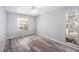 Empty bedroom features updated flooring, ample natural light, and modern ceiling fan at 2770 Keats Ter # C, Palm Harbor, FL 34684