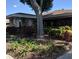Well-maintained community building with covered entrance and beautiful landscaping at 2770 Keats Ter # C, Palm Harbor, FL 34684