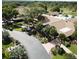 Gorgeous exterior view of community clubhouse with mature trees, landscaping, and parking at 2770 Keats Ter # C, Palm Harbor, FL 34684