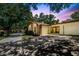 Beautiful exterior view with garage, stone details and lush trees at 2770 Keats Ter # C, Palm Harbor, FL 34684