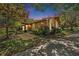 Charming single-story home featuring a stone facade, lush landscaping, and a well-maintained lawn at 2770 Keats Ter # C, Palm Harbor, FL 34684