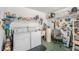 Garage featuring laundry area with washer, dryer, and storage at 2770 Keats Ter # C, Palm Harbor, FL 34684
