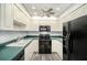 Charming kitchen featuring white cabinets, updated appliances, and lots of storage space at 2770 Keats Ter # C, Palm Harbor, FL 34684