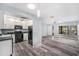 Spacious living room with attached kitchen featuring modern black appliances, offering a seamless flow for everyday living at 2770 Keats Ter # C, Palm Harbor, FL 34684