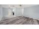 Neutral living room with light walls and dark gray vinyl plank flooring at 2770 Keats Ter # C, Palm Harbor, FL 34684