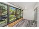 A light-filled sunroom with large windows showcasing the outdoor scenery and offering plenty of natural light at 2770 Keats Ter # C, Palm Harbor, FL 34684