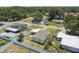 Aerial shot of a neighborhood home featuring a fenced yard, shade trees and a neatly kept lawn at 2830 Anthony St, Tampa, FL 33619