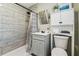 Modern bathroom with gray tile shower, new shower head, sleek vanity, and stylish shower curtain at 2830 Anthony St, Tampa, FL 33619
