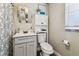 Well-lit bathroom featuring a stylish vanity, coordinated mirror, and convenient storage cabinet at 2830 Anthony St, Tampa, FL 33619