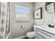 Bathroom featuring a vanity, toilet, framed art, and shower with a neutral patterned curtain at 2830 Anthony St, Tampa, FL 33619
