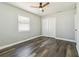 This is a standard bedroom with hardwood floors, a ceiling fan, closet and a window for natural light at 2830 Anthony St, Tampa, FL 33619