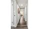 Hallway with wood-look floors leading to a bedroom, decorated with a stylish wall hanging at 2830 Anthony St, Tampa, FL 33619