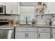 Modern kitchen featuring granite countertops, white cabinets, stainless steel appliances, and a subway tile backsplash at 2830 Anthony St, Tampa, FL 33619