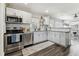 Updated kitchen featuring stainless steel appliances, white cabinets, and open layout at 2830 Anthony St, Tampa, FL 33619