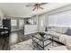 Open-concept living room showcasing modern design, wood floors, and seamless flow to the kitchen at 2830 Anthony St, Tampa, FL 33619