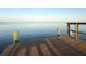 Wooden dock with posts offers a tranquil view of open water, ideal for relaxation at 3227 Bayshore Ne Blvd, St Petersburg, FL 33703