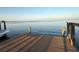 A serene view from the dock with clear water and a boat, perfect for enjoying waterfront living at 3227 Bayshore Ne Blvd, St Petersburg, FL 33703