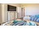 Inviting bedroom with twin beds, stylish furnishings, and a mounted television at 3282 Mangrove Point Dr, Ruskin, FL 33570