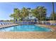 Refreshing community pool with ample lounge chairs and umbrellas, providing a relaxing oasis for residents to enjoy sunny days at 3282 Mangrove Point Dr, Ruskin, FL 33570