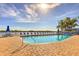 Inviting community pool area with lounge chairs, ideal for relaxing and enjoying the sunshine while overlooking the bay at 3282 Mangrove Point Dr, Ruskin, FL 33570