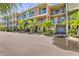 Charming townhouse complex featuring colorful facades, balconies, lush landscaping, and convenient parking at 3282 Mangrove Point Dr, Ruskin, FL 33570