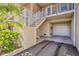 Townhouse elevation highlighting ground level garage, stairs to covered entrance, and lush landscaping at 3282 Mangrove Point Dr, Ruskin, FL 33570