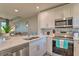 Bright, updated kitchen features quartz countertops, stainless steel appliances, and a mosaic backsplash at 3282 Mangrove Point Dr, Ruskin, FL 33570